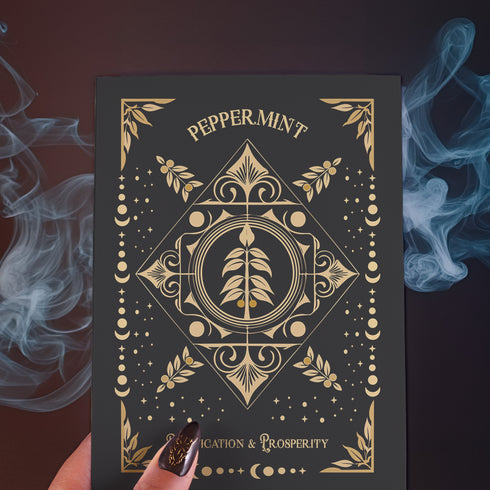 Elegant black card with gold peppermint illustration and celestial symbols. Text reads "Peppermint" and "For Purification & Prosperity" in ornate gold lettering.